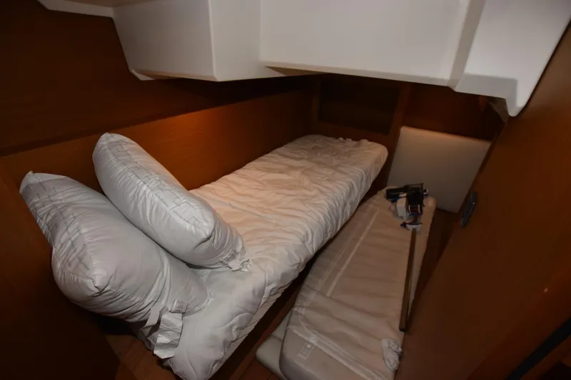  Yacht Photos Pics 2023 Beneteau Swift Trawler 41 Fly cabin with cozy bedding and wooden interior.