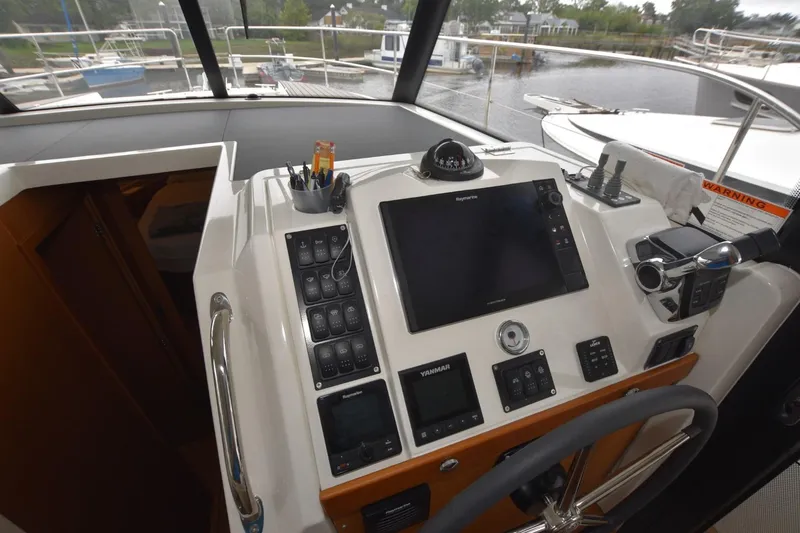  Yacht Photos Pics 2023 Beneteau Swift Trawler 41 Fly helm with navigation controls and steering wheel.