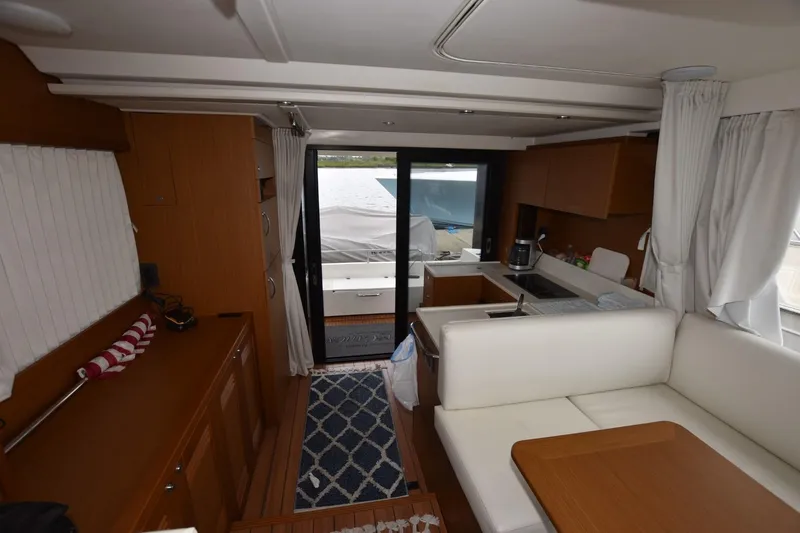  Yacht Photos Pics Interior of 2023 Beneteau Swift Trawler 41 Fly, featuring modern kitchen and seating area.