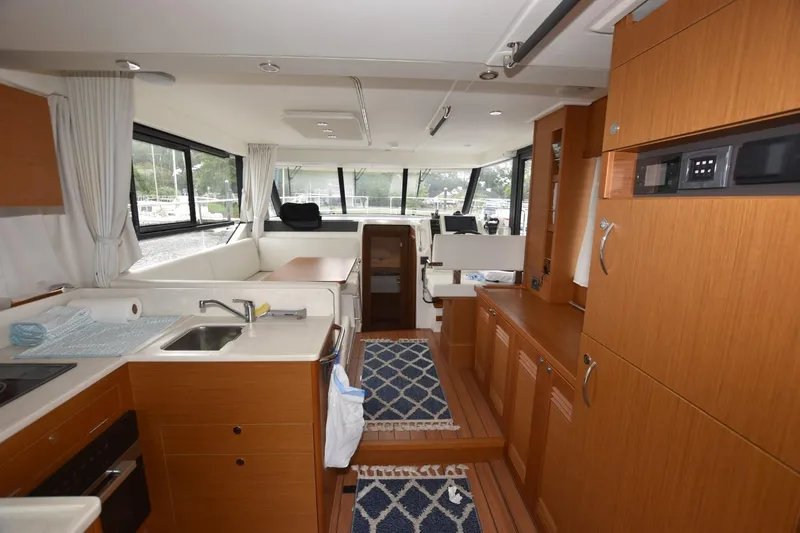 Yacht Photos Pics Interior of 2023 Beneteau Swift Trawler 41 Fly, featuring modern kitchen and seating area.