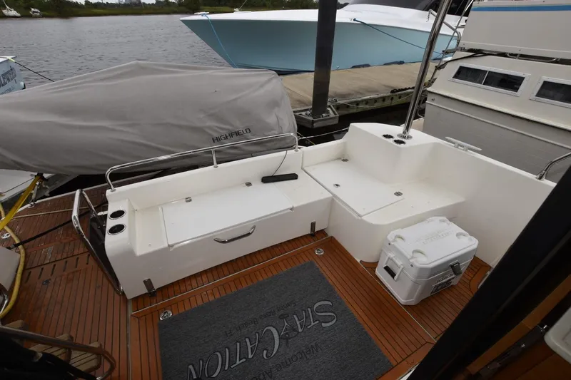  Yacht Photos Pics 2023 Beneteau Swift Trawler 41 Fly deck with seating and storage, docked by the water.