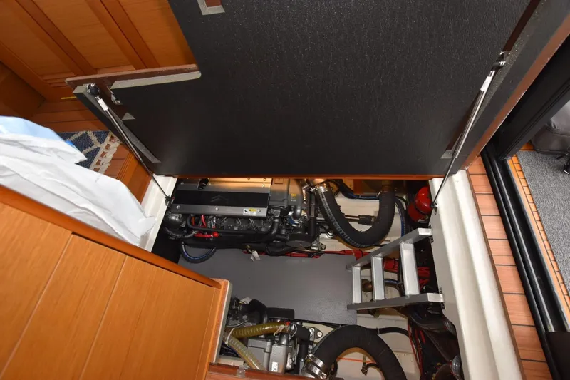  Yacht Photos Pics Engine compartment of 2023 Beneteau Swift Trawler 41 Fly with visible machinery and ladder.