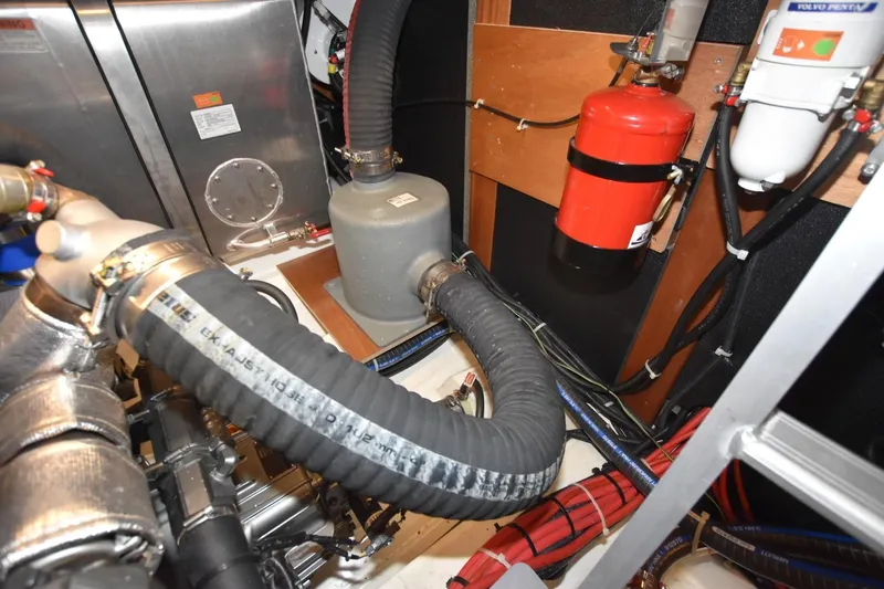  Yacht Photos Pics Engine room of 2023 Beneteau Swift Trawler 41 Fly with hoses and fire extinguisher.