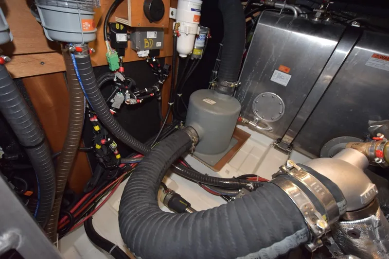  Yacht Photos Pics Engine room of 2023 Beneteau Swift Trawler 41 Fly, showcasing complex piping and machinery.