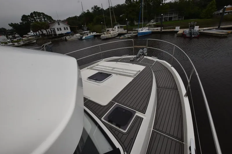  Yacht Photos Pics 2023 Beneteau Swift Trawler 41 Fly, docked, showcasing sleek deck design and marina backdrop.