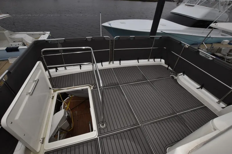  Yacht Photos Pics 2023 Beneteau Swift Trawler 41 Fly deck with open hatch, docked at marina.