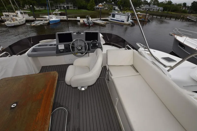  Yacht Photos Pics Flybridge of 2023 Beneteau Swift Trawler 41 Fly with helm, seating, and marina view.