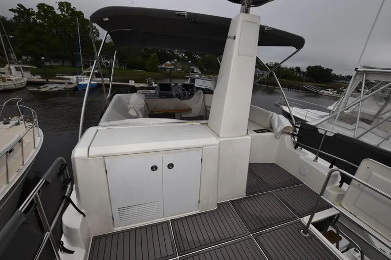  Yacht Photos Pics 2023 Beneteau Swift Trawler 41 Flybridge with covered seating area and helm station.