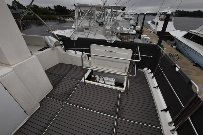  Yacht Photos Pics 2023 Beneteau Swift Trawler 41 Fly deck with open hatch, docked at marina.