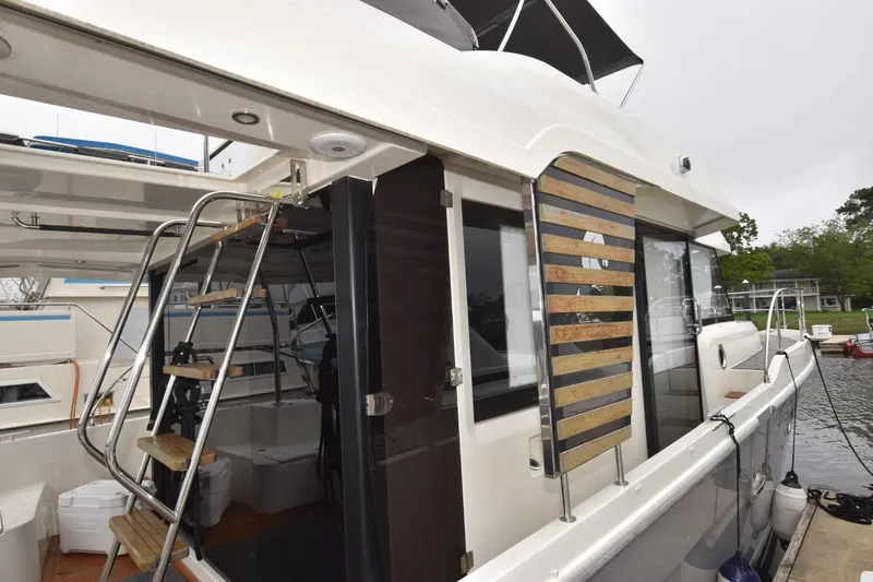  Yacht Photos Pics 2023 Beneteau Swift Trawler 41 Fly, docked, showcasing exterior design and ladder access.