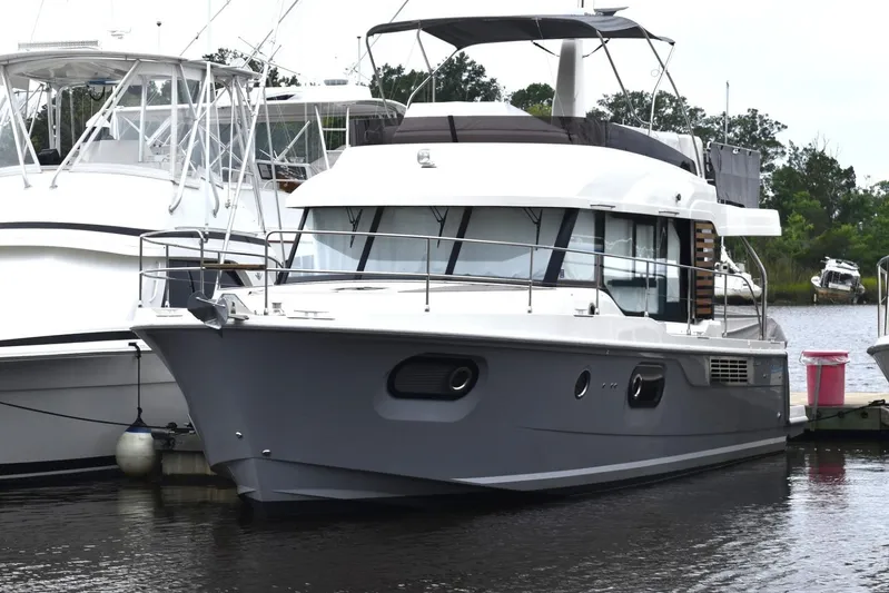  Yacht Photos Pics 2023 Beneteau Swift Trawler 41 Fly docked at marina, sleek design, modern features.