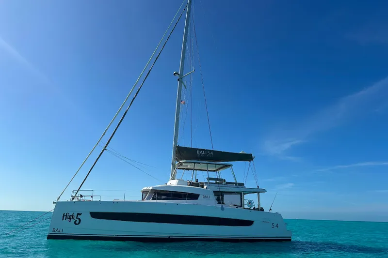 High 5 Yacht Photos Pics 2024 Bali 5.4 catamaran sailing on clear blue ocean under sunny sky.
