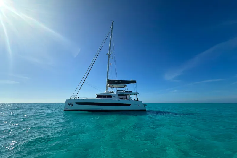 High 5 Yacht Photos Pics 2024 Bali 5.4 catamaran sailing on clear turquoise waters under a bright blue sky.