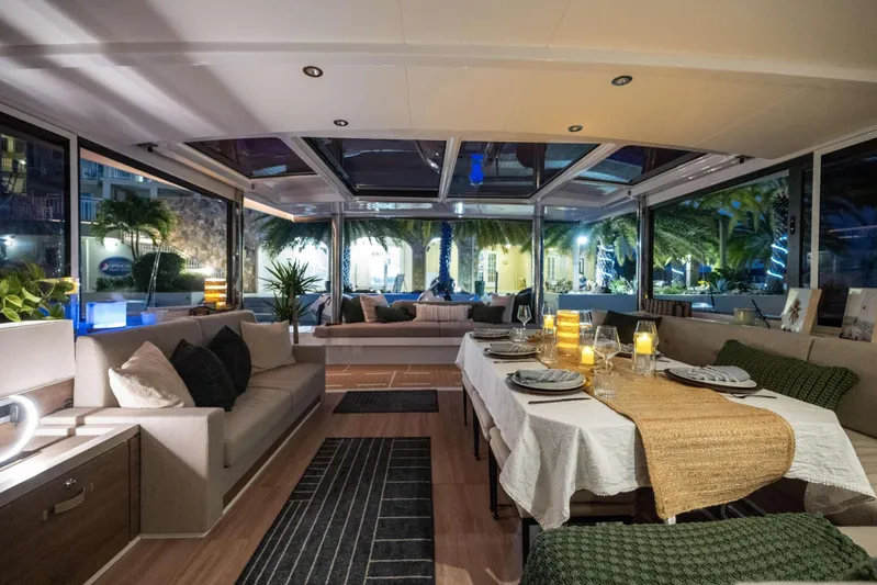 High 5 Yacht Photos Pics Luxurious interior of 2024 Bali 5.4 yacht with elegant dining setup and cozy seating.