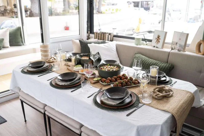 High 5 Yacht Photos Pics Elegant dining setup on a 2024 Bali 5.4 yacht, featuring a beautifully arranged table.