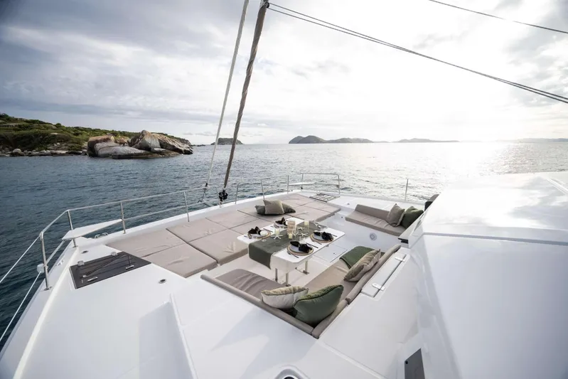 High 5 Yacht Photos Pics Luxurious 2024 Bali 5.4 yacht deck with elegant seating, ocean view, and dining setup.