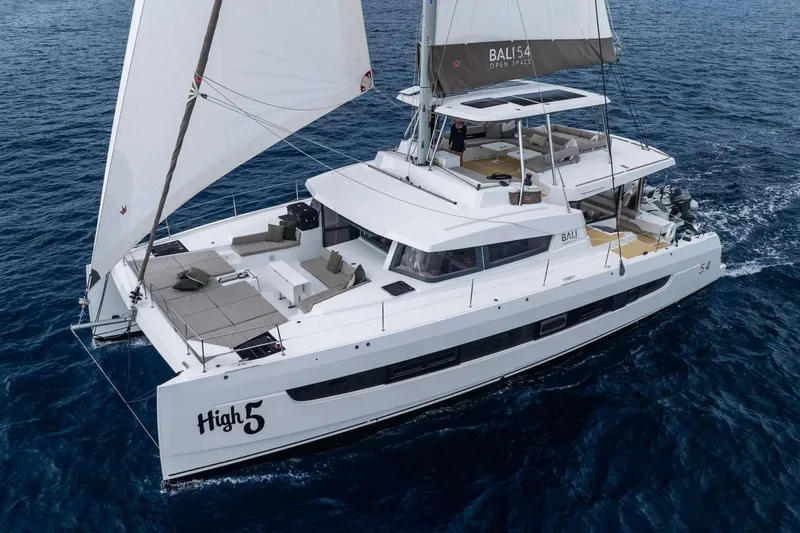 High 5 Yacht Photos Pics 2024 Bali 5.4 catamaran sailing on open ocean, showcasing spacious deck and modern design.