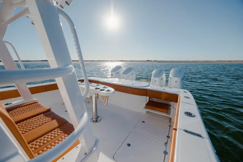  Yacht Photos Pics 2024 Invincible 46 Pilothouse boat on water, featuring luxurious seating and powerful engines.