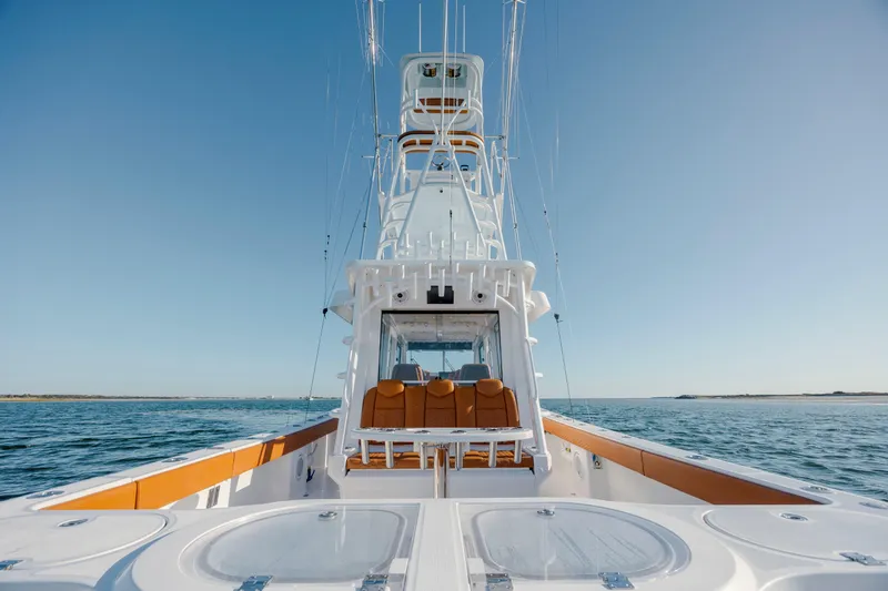  Yacht Photos Pics 2024 Invincible 46 Pilothouse yacht on open water, showcasing sleek design and luxury features.