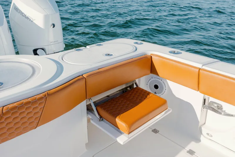  Yacht Photos Pics 2024 Invincible 46 Pilothouse boat interior with tan seating and Mercury engine.