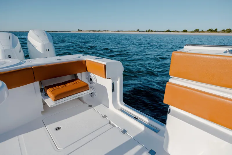  Yacht Photos Pics 2024 Invincible 46 Pilothouse boat interior with orange seating, ocean view.