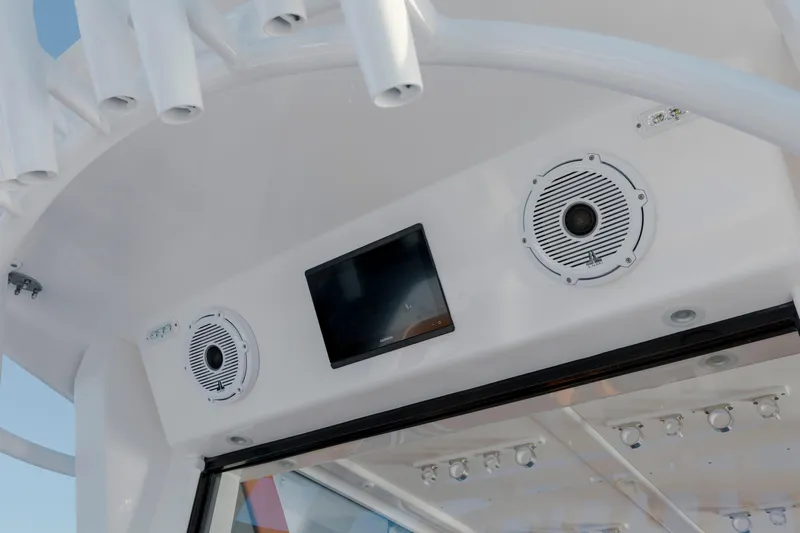  Yacht Photos Pics 2024 Invincible 46 Pilothouse interior with speakers and screen, showcasing modern design.