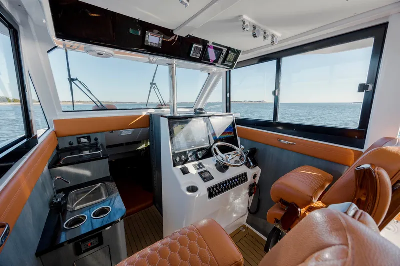  Yacht Photos Pics 2024 Invincible 46 Pilothouse interior with modern helm and luxurious seating.