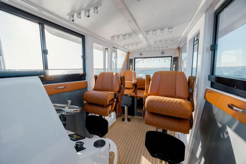  Yacht Photos Pics 2024 Invincible 46 Pilothouse interior with luxurious seating and panoramic windows.