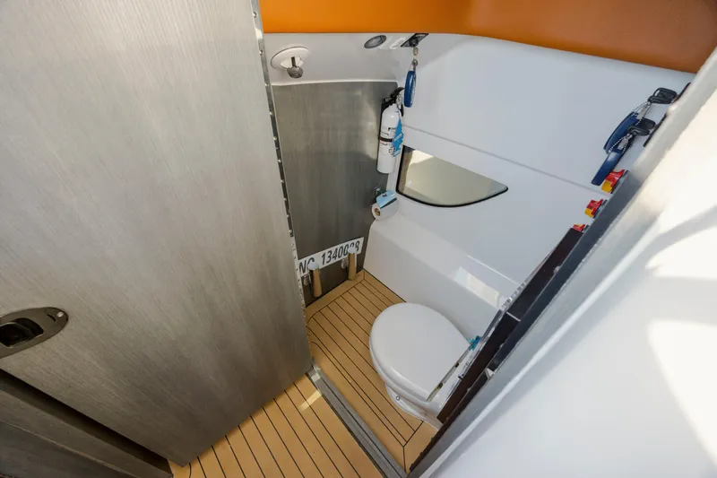  Yacht Photos Pics 2024 Invincible 46 Pilothouse bathroom with modern fixtures and wooden flooring.