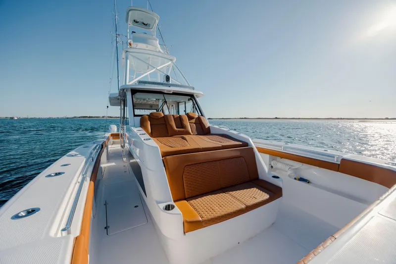  Yacht Photos Pics 2024 Invincible 46 Pilothouse yacht with luxurious seating on open water.