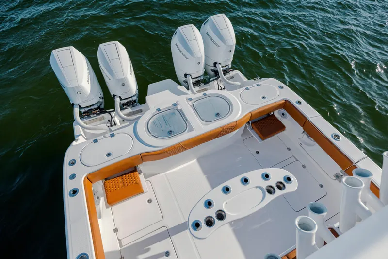  Yacht Photos Pics 2024 Invincible 46 Pilothouse boat with four powerful outboard engines on open water.