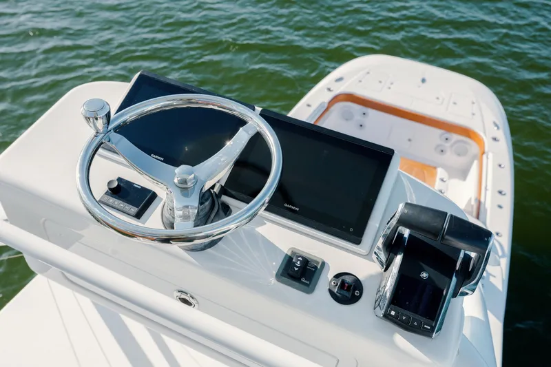  Yacht Photos Pics 2024 Invincible 46 Pilothouse helm with modern controls and dual screens on water.