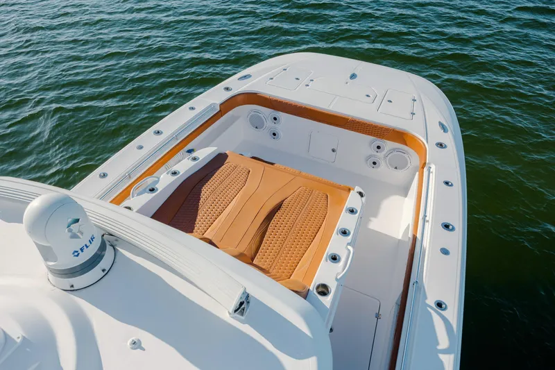  Yacht Photos Pics 2024 Invincible 46 Pilothouse boat deck with tan seating, on calm water.