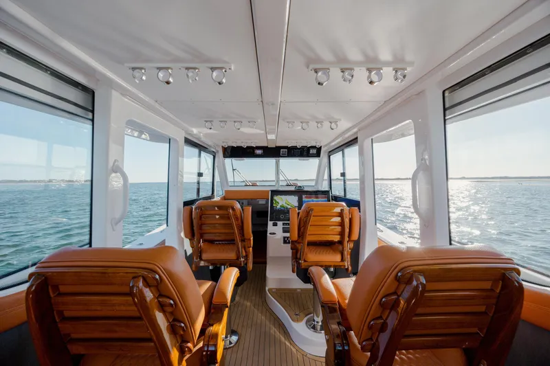  Yacht Photos Pics 2024 Invincible 46 Pilothouse interior with luxurious seating and panoramic ocean views.