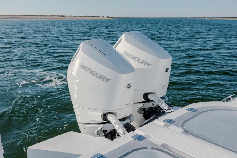  Yacht Photos Pics Twin Mercury outboard engines on 2024 Invincible 46 Pilothouse boat in open water.