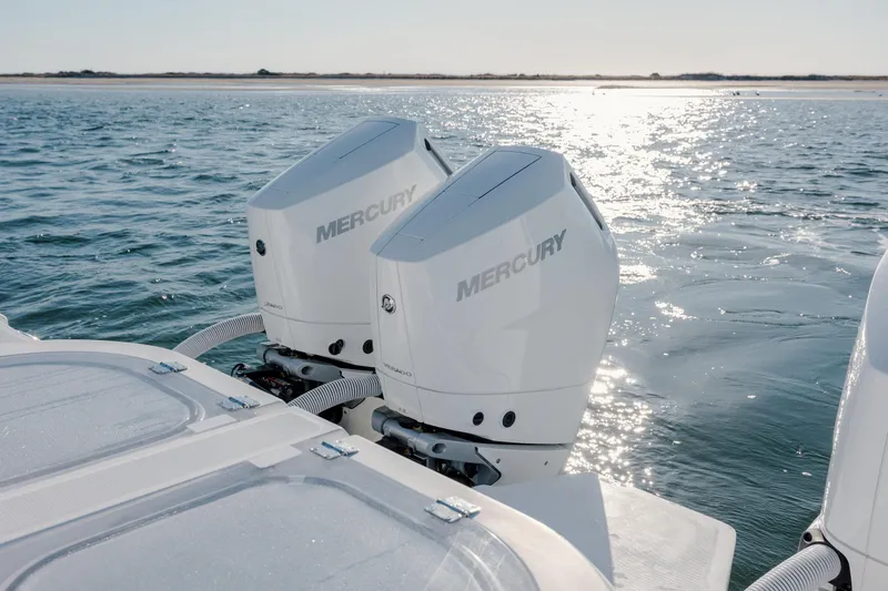  Yacht Photos Pics 2024 Invincible 46 Pilothouse with twin Mercury outboard engines on the water.