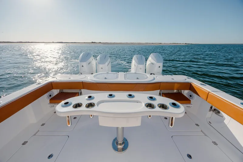  Yacht Photos Pics 2024 Invincible 46 Pilothouse boat with sleek deck and powerful engines on open water.