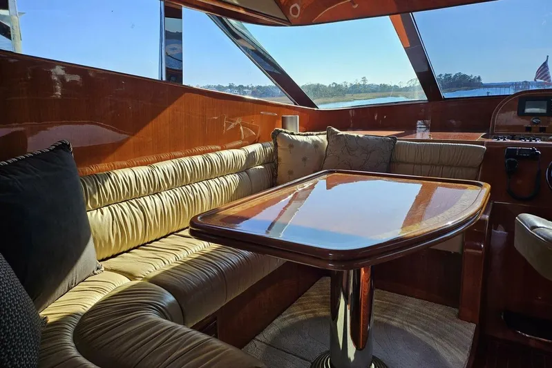  Yacht Photos Pics Luxurious 2003 Johnson FLY yacht interior with plush seating and polished wood table.