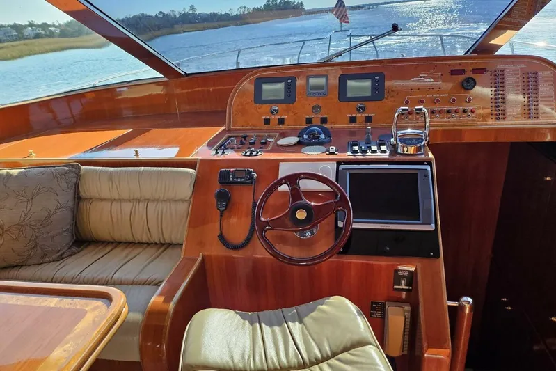  Yacht Photos Pics 2003 Johnson FLY yacht cockpit with wooden dashboard and modern navigation equipment.