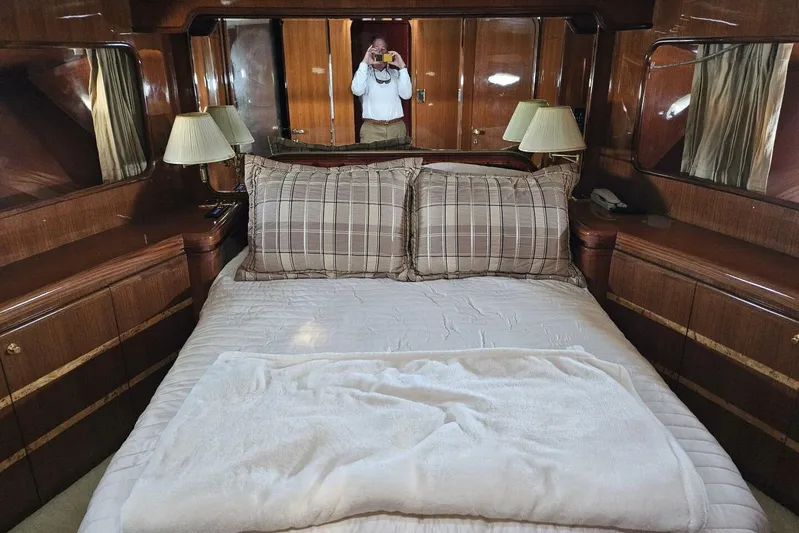  Yacht Photos Pics Luxurious bedroom interior on a 2003 Johnson FLY yacht with elegant wood finishes.