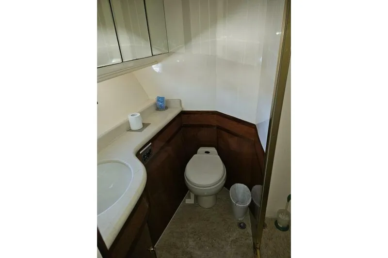  Yacht Photos Pics Compact bathroom in a 2003 Johnson FLY model, featuring a toilet and sink.