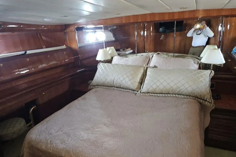  Yacht Photos Pics Luxurious bedroom interior on 2003 Johnson FLY yacht with elegant wood paneling and plush bedding.