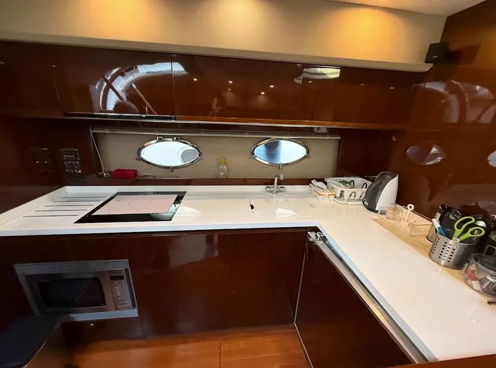  Yacht Photos Pics Luxurious kitchen interior of 2009 Princess V53 yacht with modern appliances and sleek design.