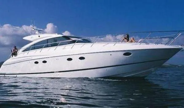  Yacht Photos Pics 2009 Princess V53 yacht cruising on open water under a clear blue sky.