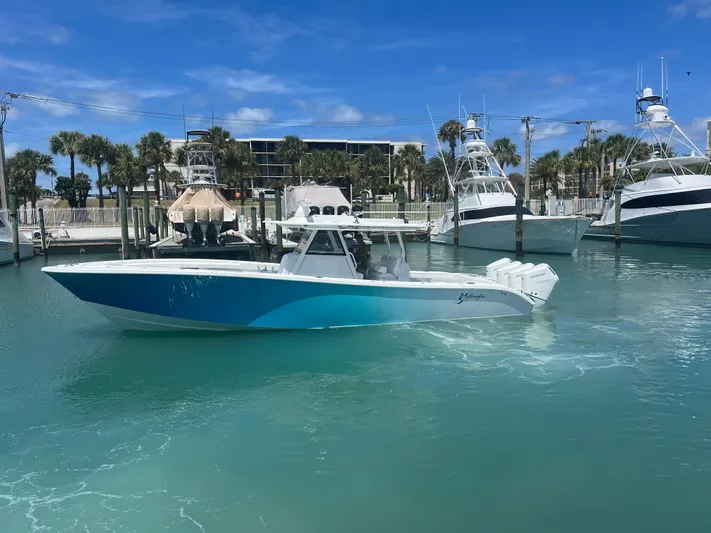  Yacht Photos Pics 2023 Yellowfin 39 Offshore boat in marina, clear blue water, sunny day.