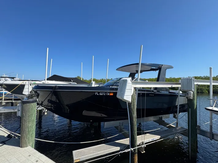  Yacht Photos Pics Aviara 28 Surf 2025 on a boat lift at the dock.