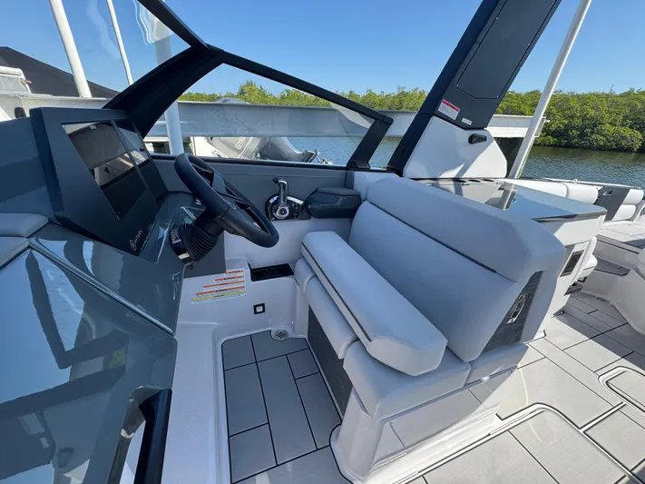  Yacht Photos Pics Interior of Aviara 28 Surf 2025 with helm and seating area.
