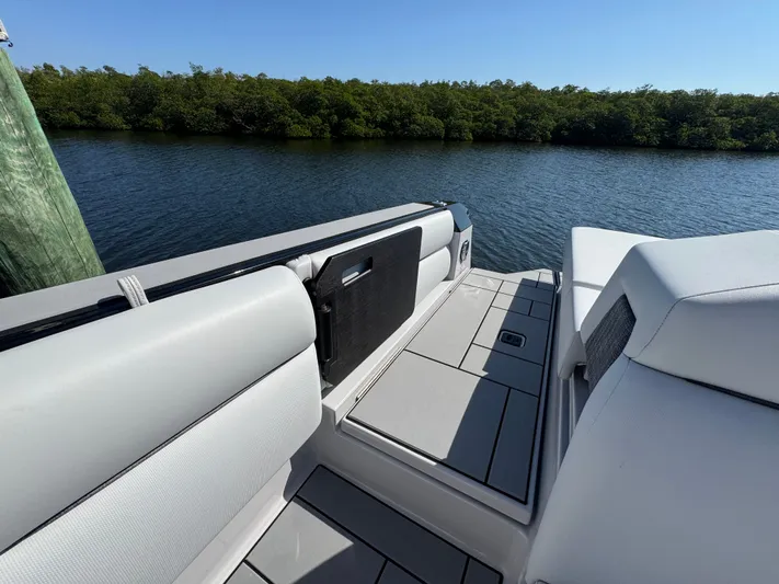  Yacht Photos Pics Aviara 28 Surf 2025 on calm water with green shoreline.