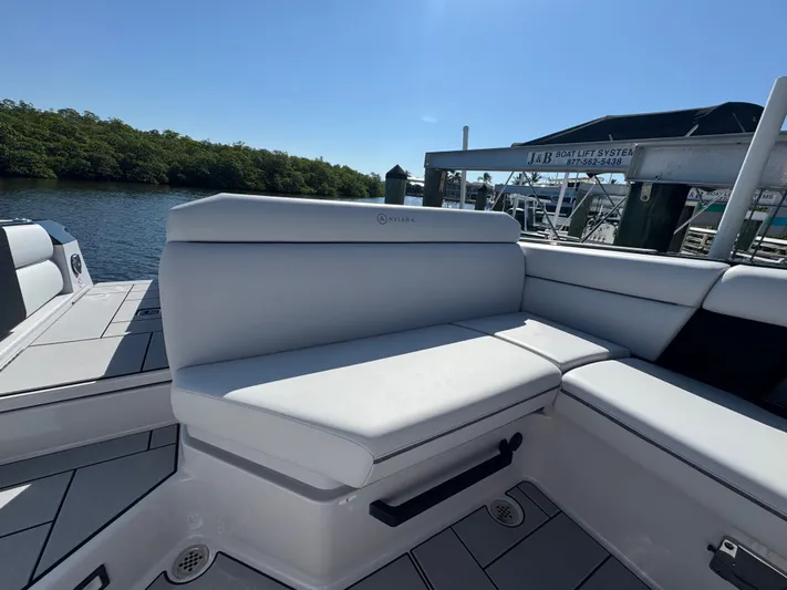  Yacht Photos Pics 2025 Aviara 28 Surf boat with luxurious seating by the water.
