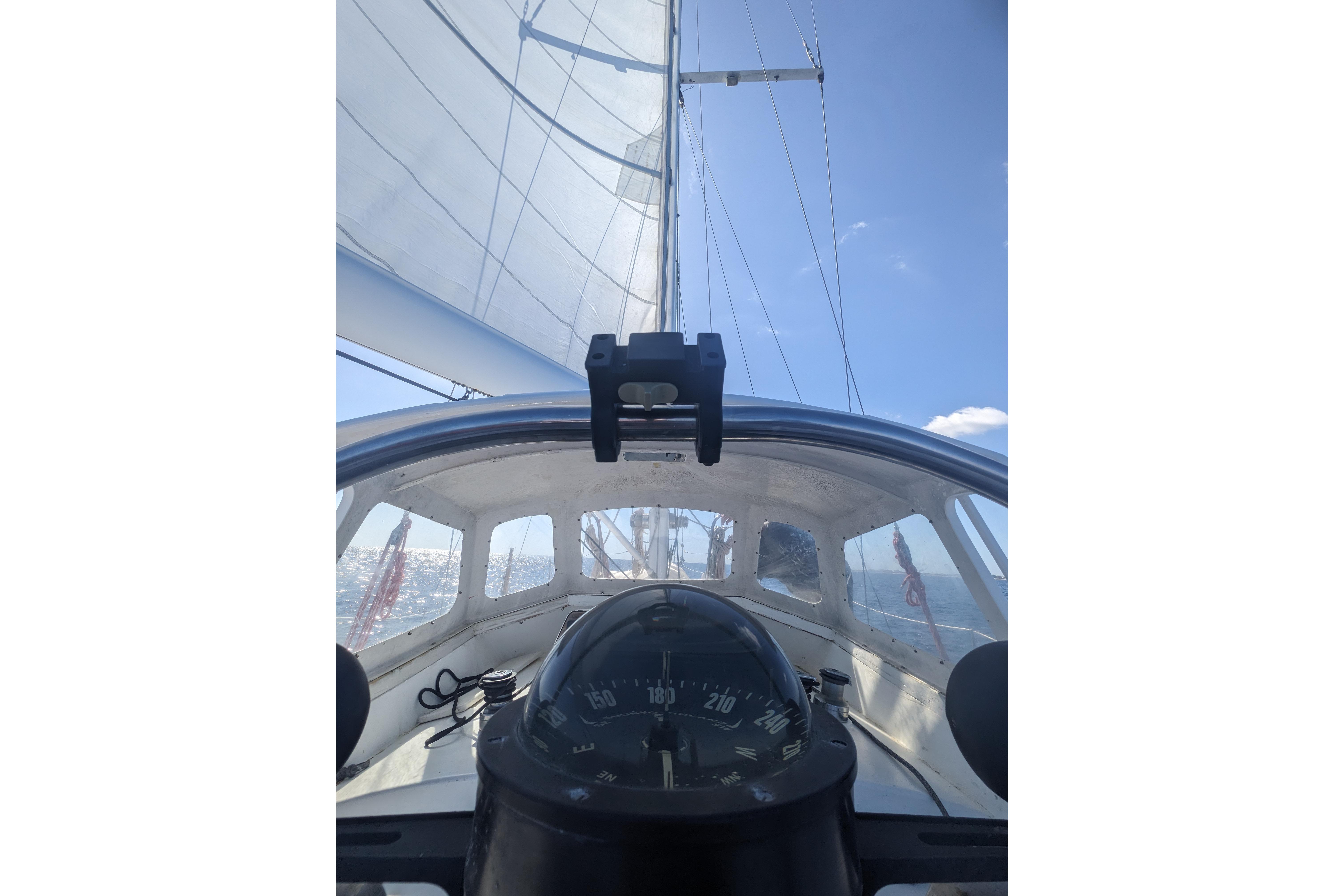 Cockpit view of 1992 Bruce Bingham Custom 47 sailboat with compass and sails.